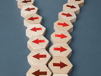 diverging arrows on wooden blocks